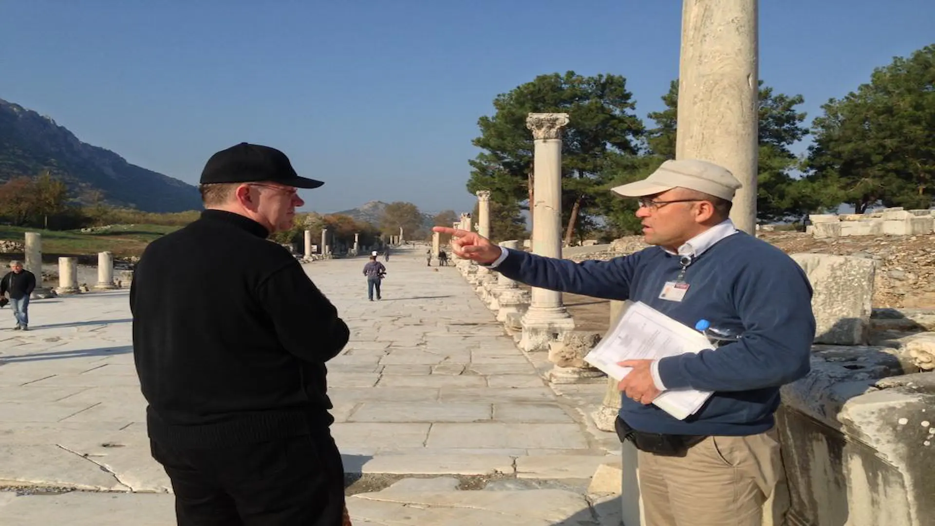 Expert Ephesus guide pointing out architectural details on the Marble Road to a private client.