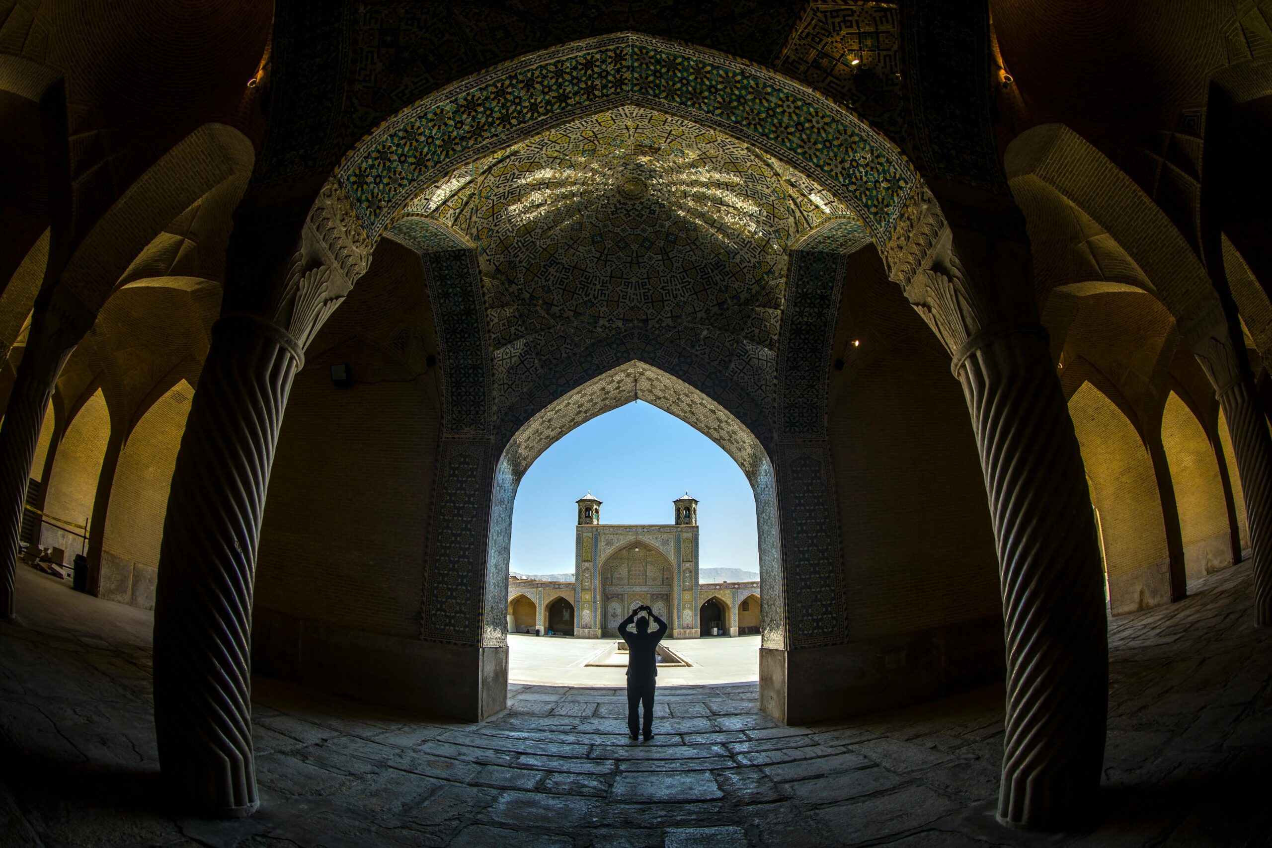 Explore the stunning arches and intricate details of the historic Vakil Mosque in Shiraz, Iran.