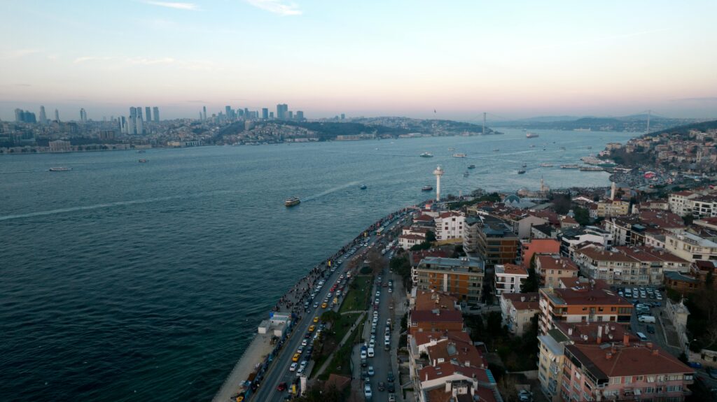 Scenic aerial view of İstanbul's Bosphorus at sunset, showcasing city skyline and waterway.