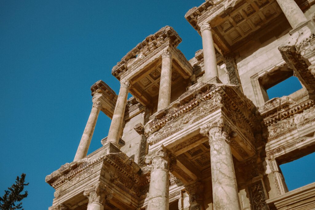 Detailed view of the historic Ephesus Library's Roman architecture under a clear blue sky.